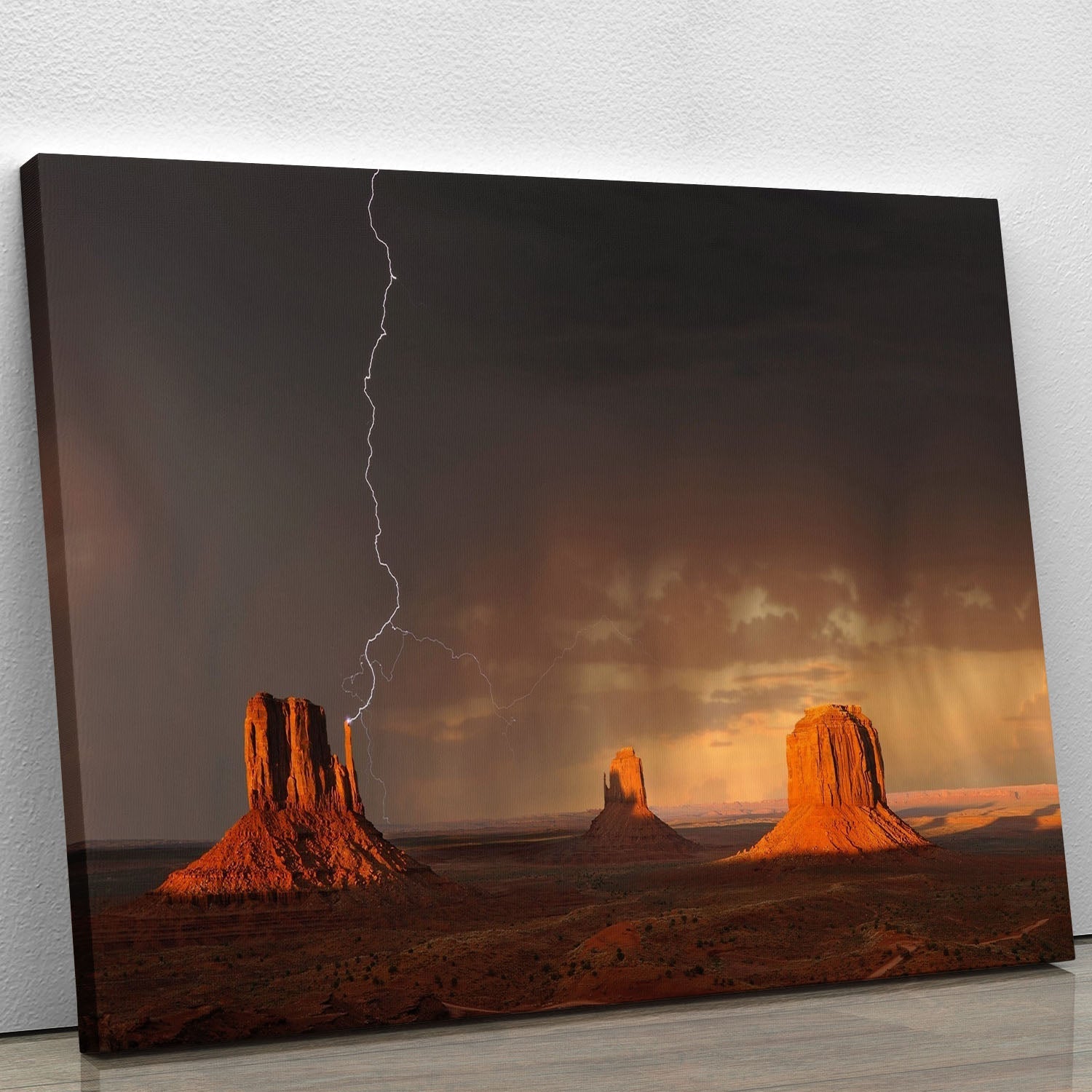 A stunning canvas print of Monument Valley showcasing its iconic sandstone buttes and vibrant sunset colors.