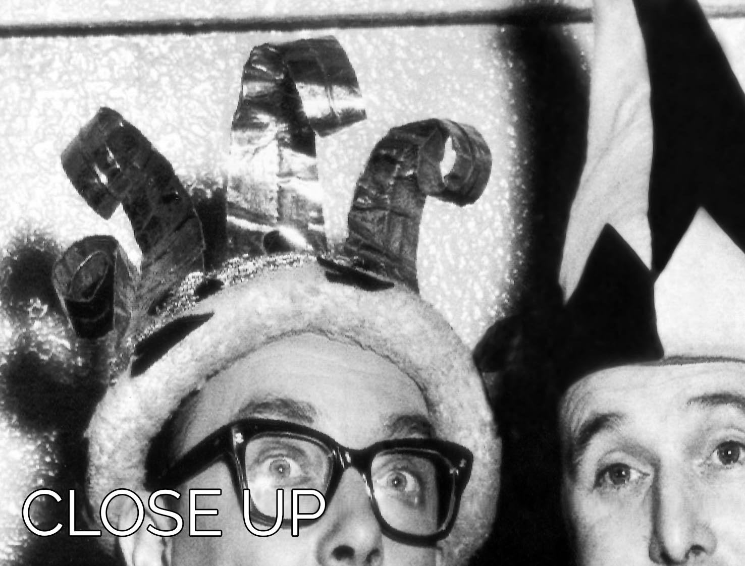 Morecambe and Wise dressed as court jesters on a vibrant 3-panel canvas print, showcasing their playful expressions and colorful costumes.