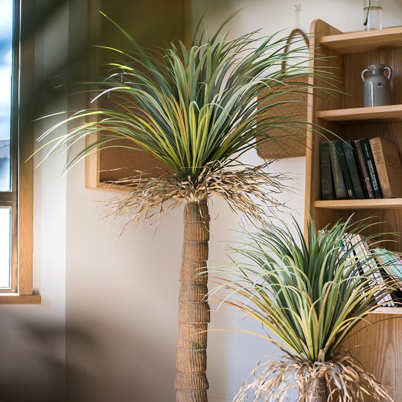 A lush Moroccan Artificial Palm Tree in a decorative pot, showcasing vibrant green leaves and realistic details, perfect for home decor.