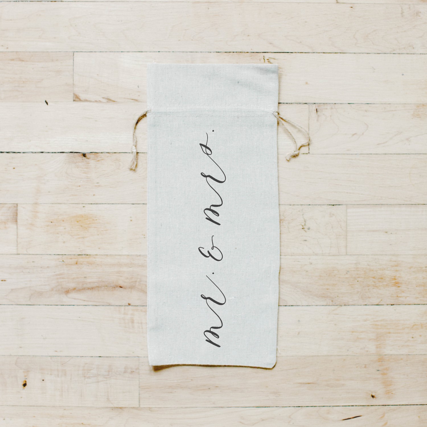 Stylish Mr. & Mrs. Calligraphy Wine Bag made from organic linen with twine drawstrings, featuring elegant calligraphy design.