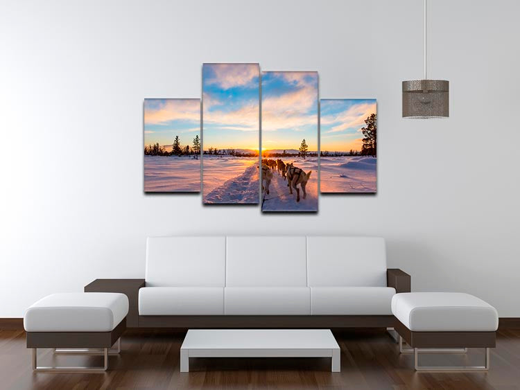 A captivating 4-split canvas artwork depicting a musher and passenger in a dog sleigh, pulled by energetic huskies in a snowy winter landscape.
