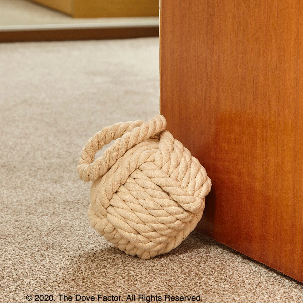 Nautical Rope Knot Fabric Door Stop in off white, tan, cream, and egg shell colors, featuring a soft cotton texture and integrated handle.