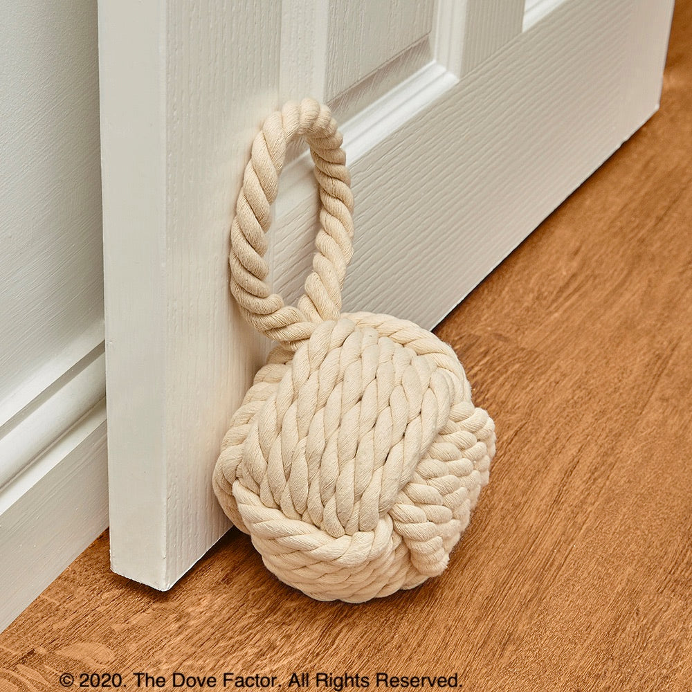 Nautical Rope Knot Fabric Door Stop in off white, tan, cream, and egg shell colors, featuring a soft cotton texture and integrated handle.