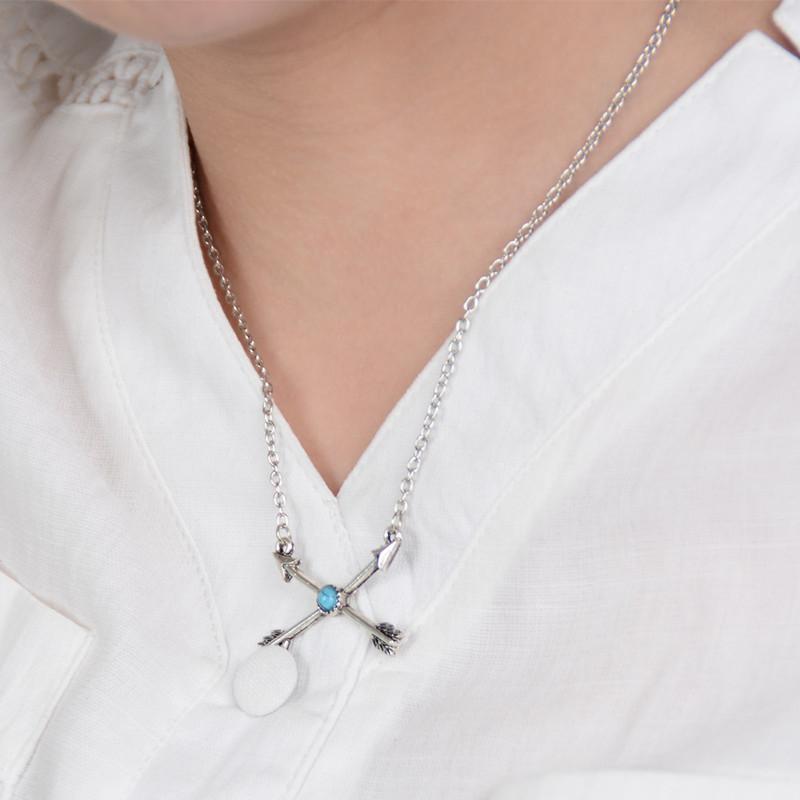 A stylish silver plated turquoise arrow pendant on a delicate chain, showcasing bohemian design elements.
