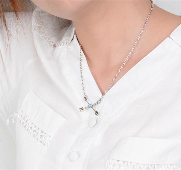A stylish silver plated turquoise arrow pendant on a delicate chain, showcasing bohemian design elements.