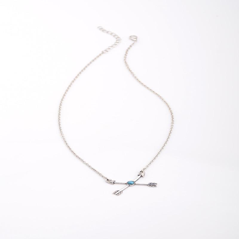 A stylish silver plated turquoise arrow pendant on a delicate chain, showcasing bohemian design elements.