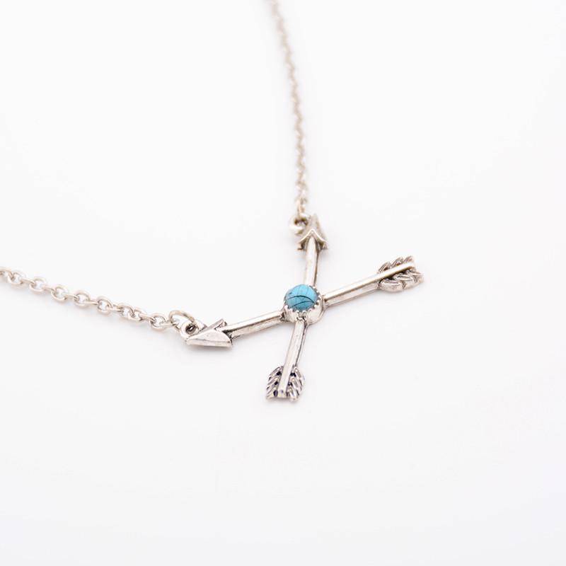 A stylish silver plated turquoise arrow pendant on a delicate chain, showcasing bohemian design elements.