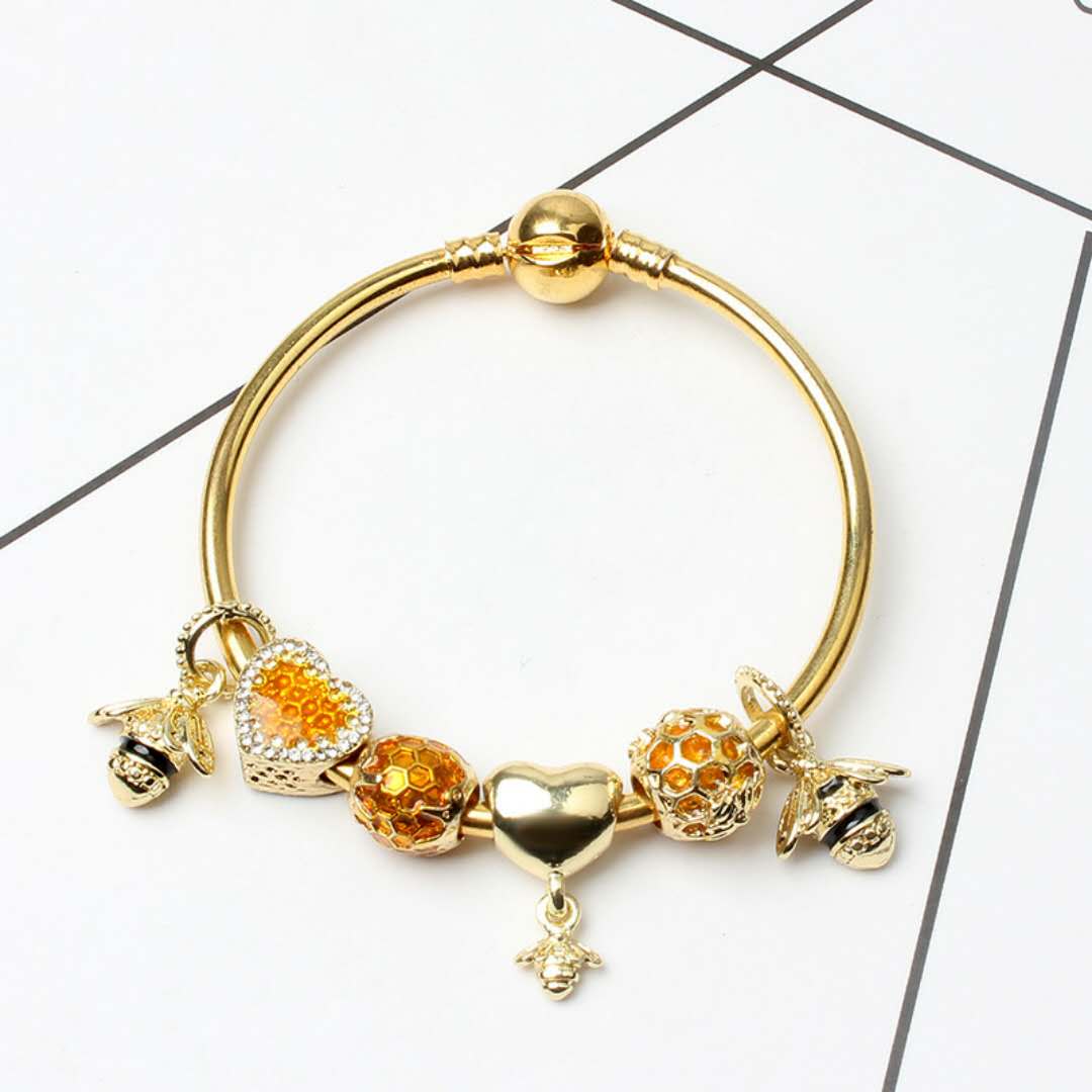 New Fashion Bracelet featuring European charms, love heart beads, and a queen bee design, elegantly displayed on a soft background.