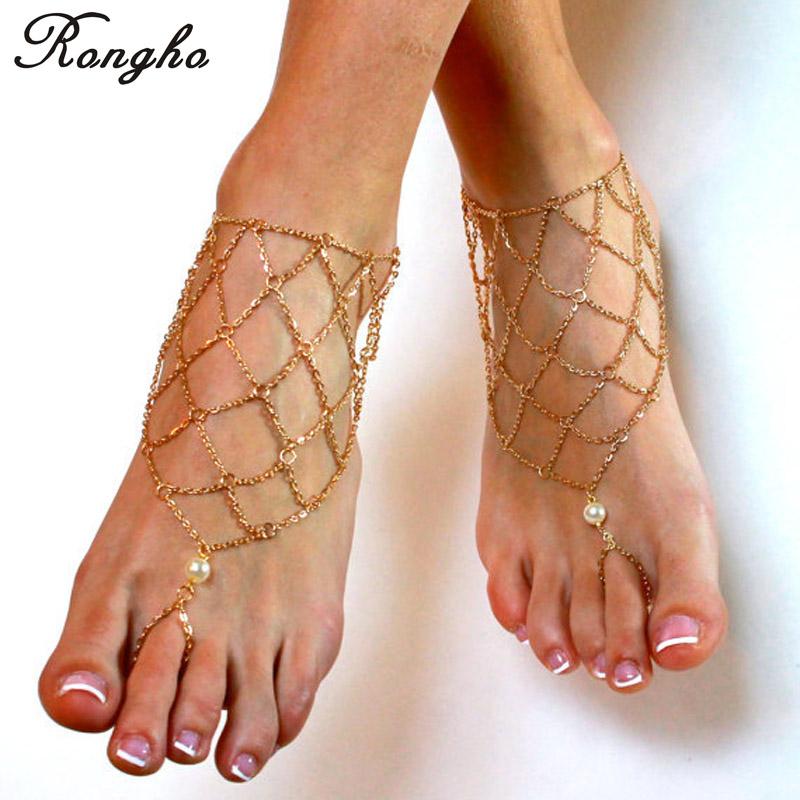 A pair of elegant gold metal chain anklets designed for women, perfect for barefoot sandals and beachwear.