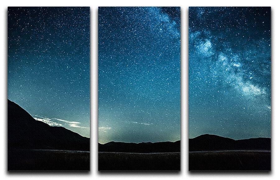 A stunning 3-panel canvas artwork depicting the Milky Way over majestic mountains, perfect for home decor.