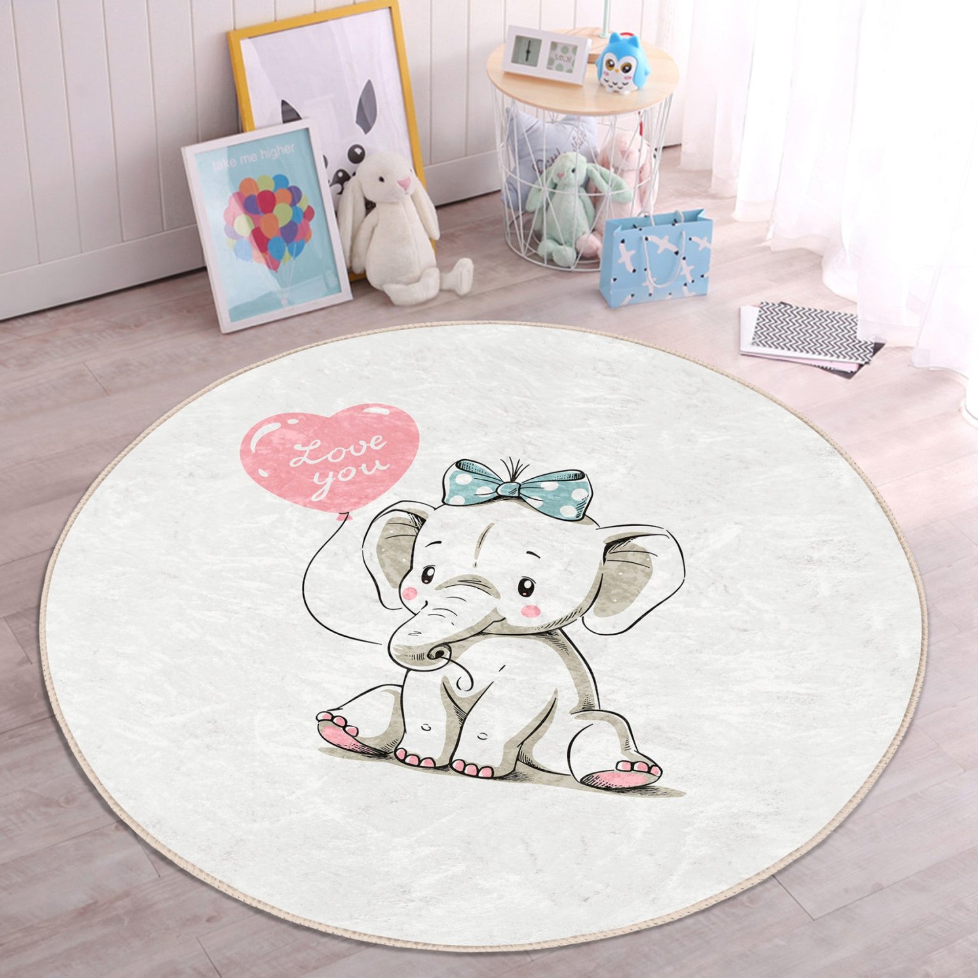 A soft, round nursery rug featuring a charming elephant print, perfect for adding comfort and style to a baby's room.