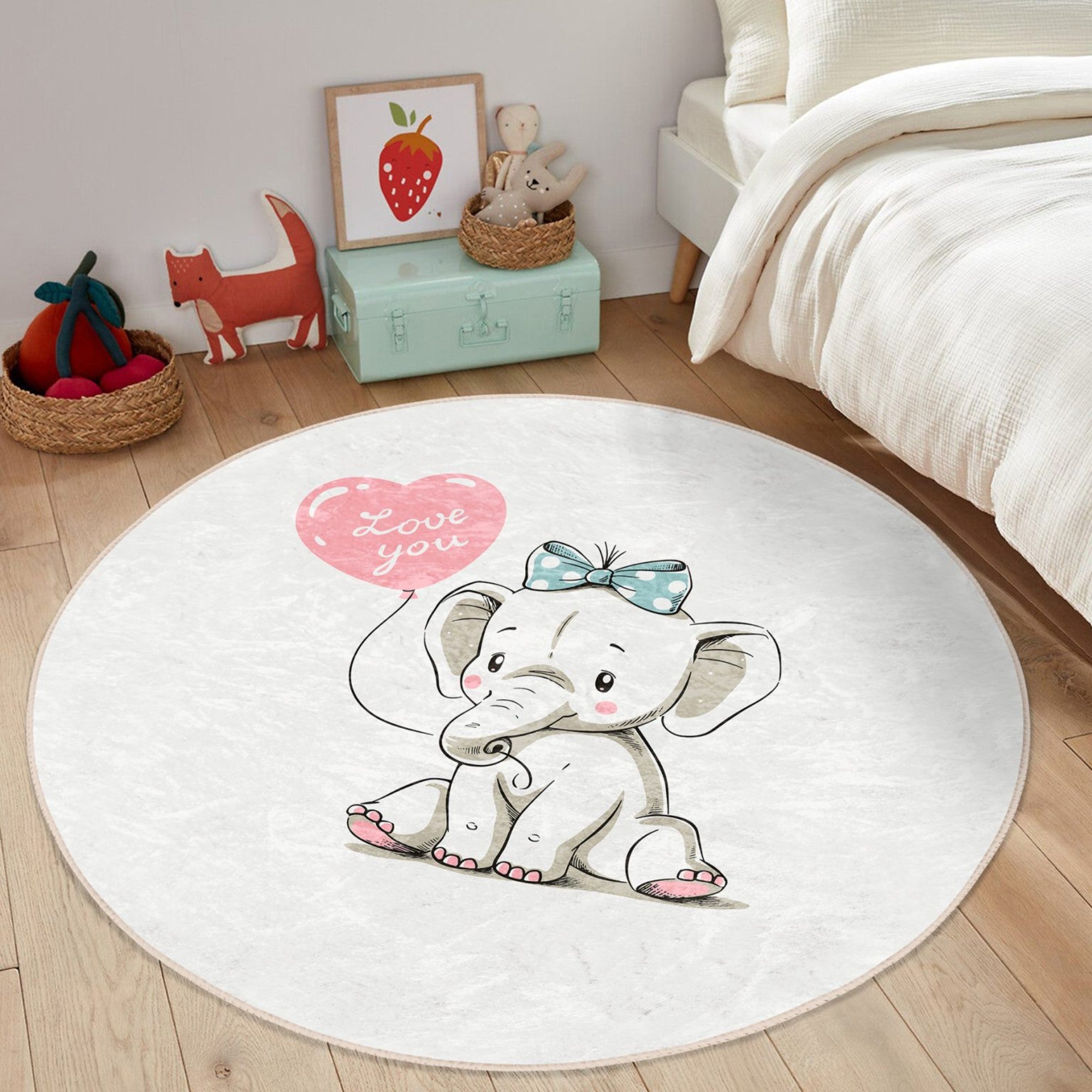 A soft, round nursery rug featuring a charming elephant print, perfect for adding comfort and style to a baby's room.