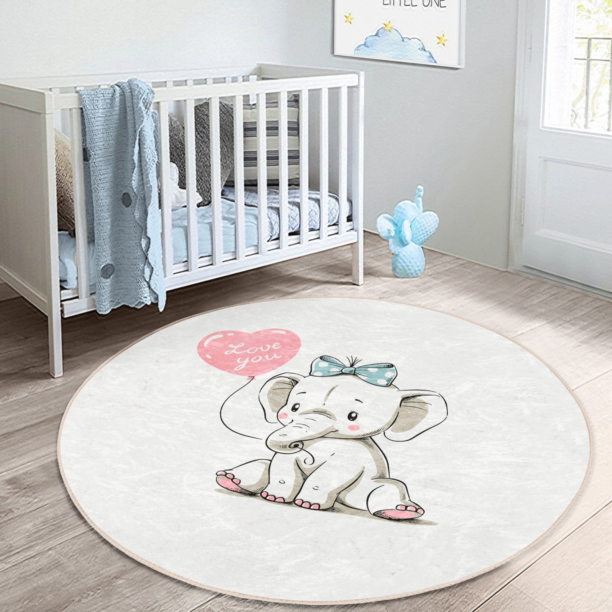 A soft, round nursery rug featuring a charming elephant print, perfect for adding comfort and style to a baby's room.
