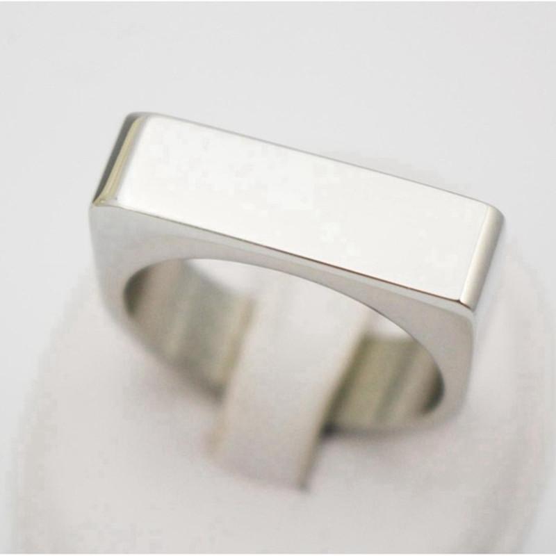 A shiny high polish finish silver personalized ring made from 316L stainless steel, showcasing a custom logo engraving.