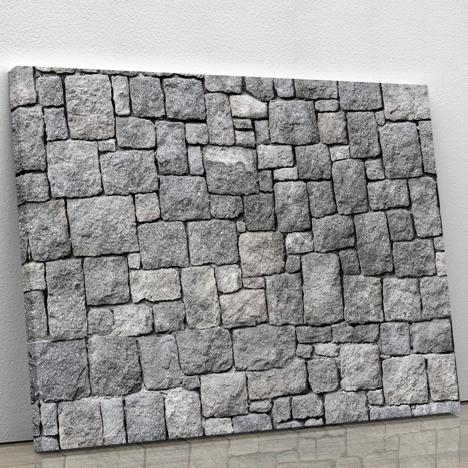A beautiful canvas print featuring an old gray stone wall, showcasing intricate textures and rustic charm, perfect for home or office decor.