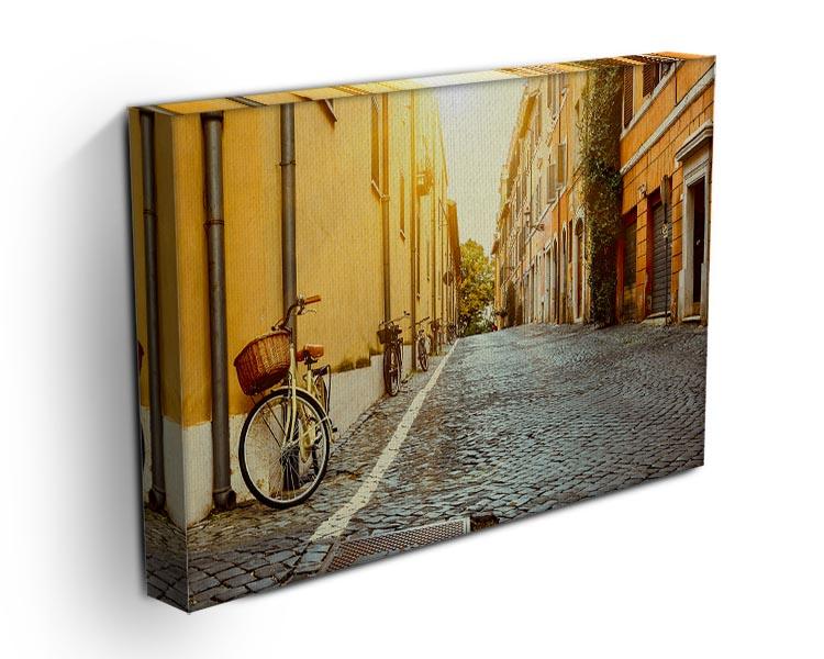 A beautiful canvas print of an old street in Rome, showcasing charming architecture and vibrant colors, perfect for home decor.