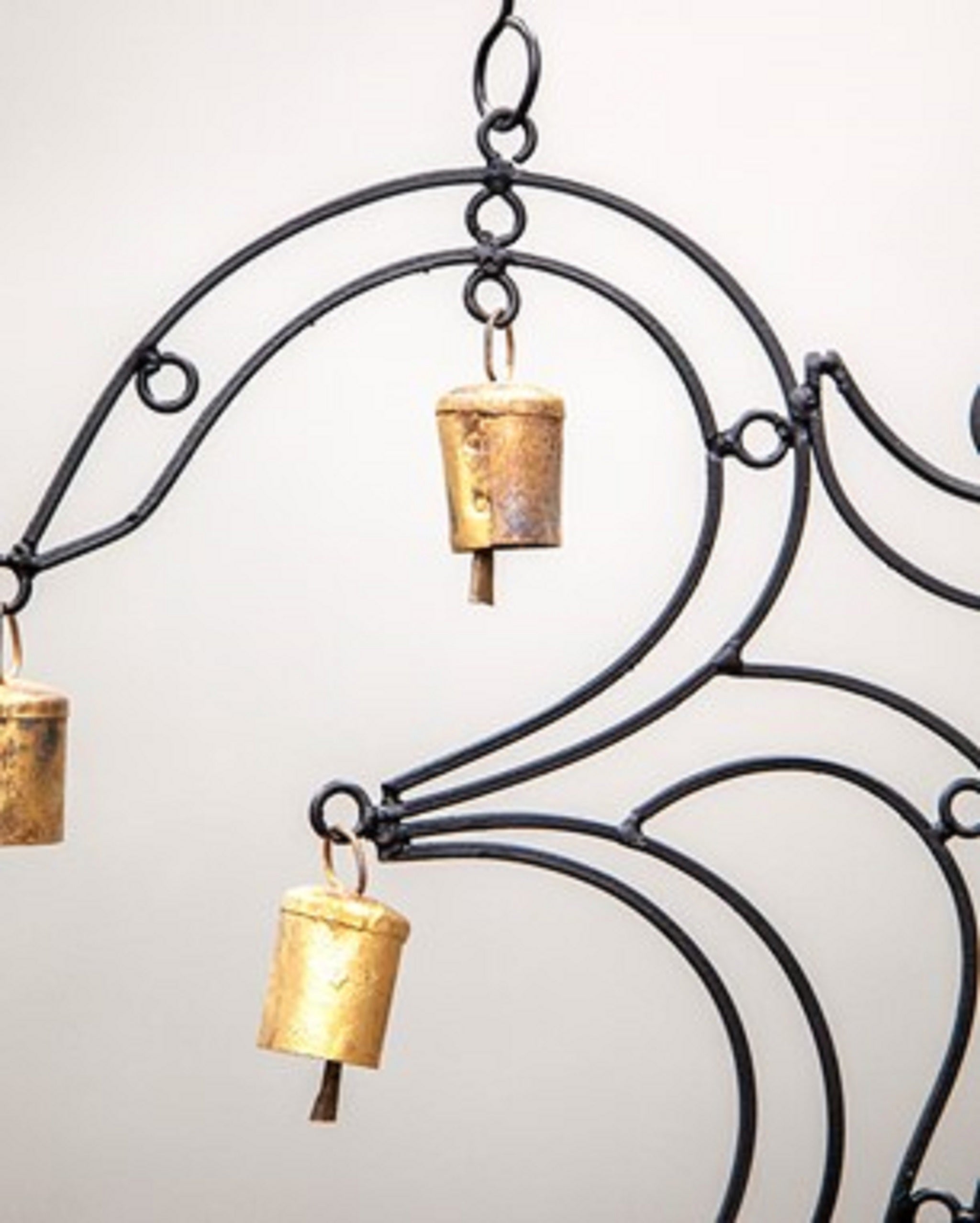 A beautifully handcrafted OM Brass chime featuring 9 brass bells, showcasing intricate designs and vibrant colors, perfect for home decor.