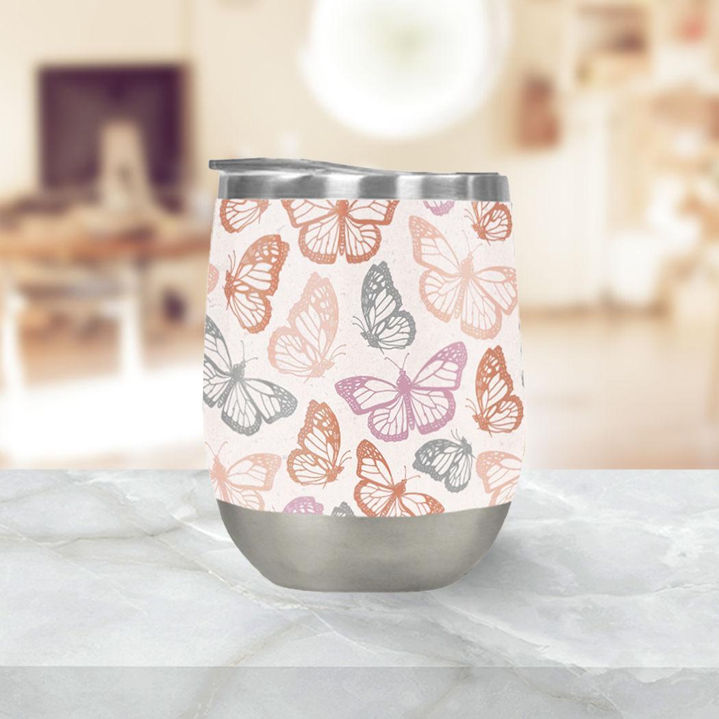 Orange and pink butterfly wine tumbler with double-wall insulation, perfect for outdoor use.