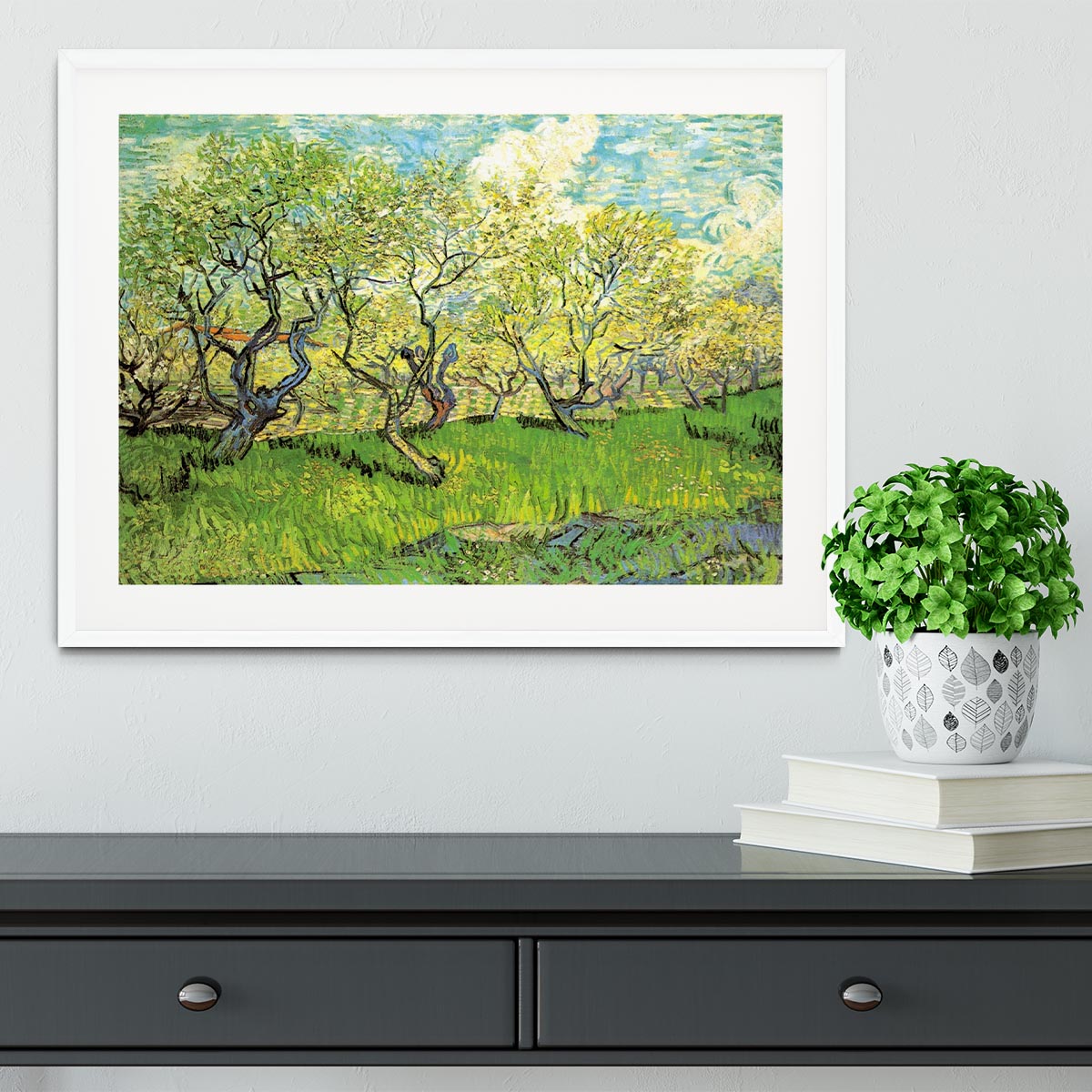 Framed print of Van Gogh's Orchard in Blossom 2, showcasing vibrant colors and intricate details in a stylish frame.