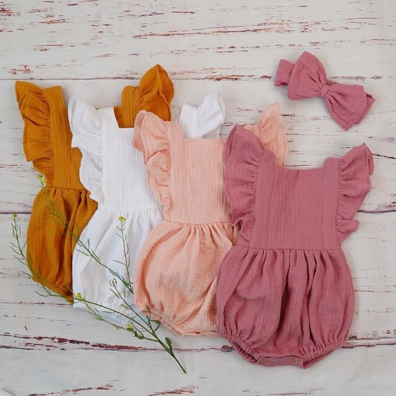 Organic cotton baby girl clothes featuring a sleeveless romper with ruffles and a matching headband, perfect for summer wear.