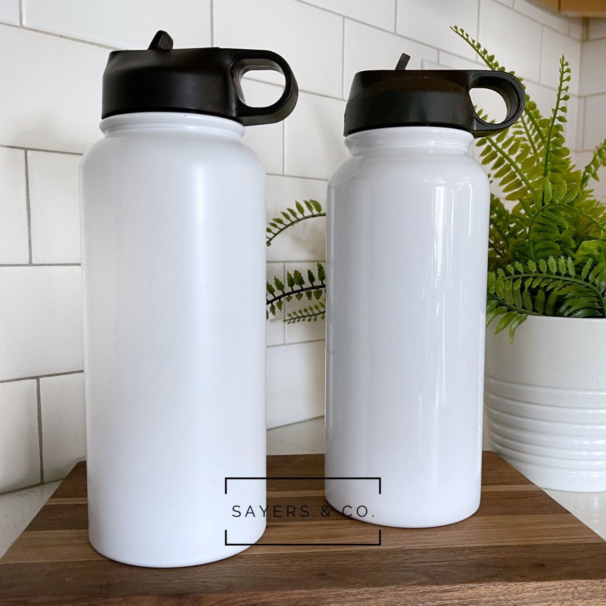 Pack of 30 white sublimation sport bottle tumblers in 32oz and 18oz sizes, showcasing their sleek stainless steel design.