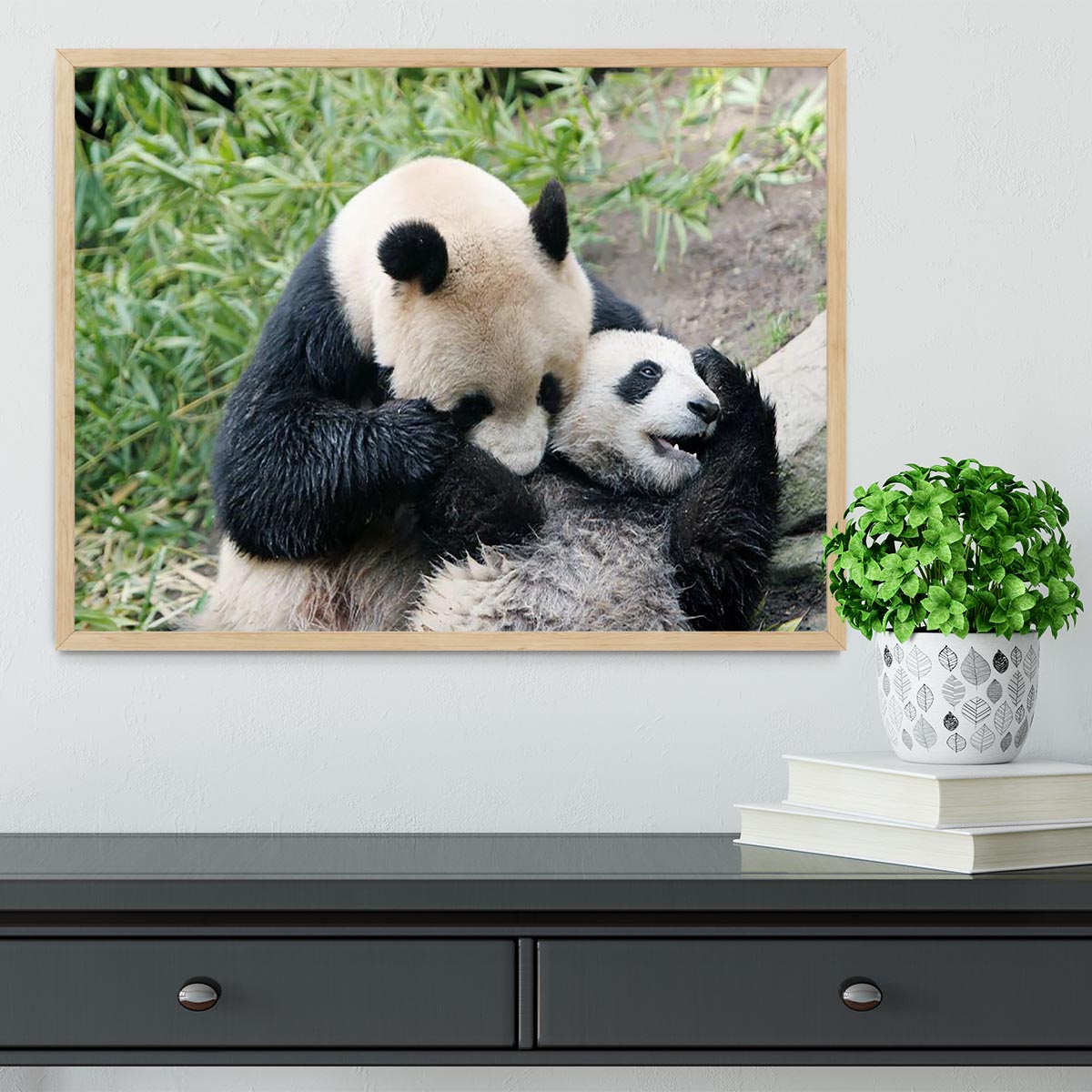 Framed print of a panda bear and her cub, showcasing vibrant colors and intricate details in a handmade frame.
