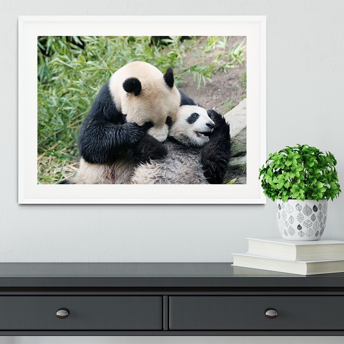 Framed print of a panda bear and her cub, showcasing vibrant colors and intricate details in a handmade frame.