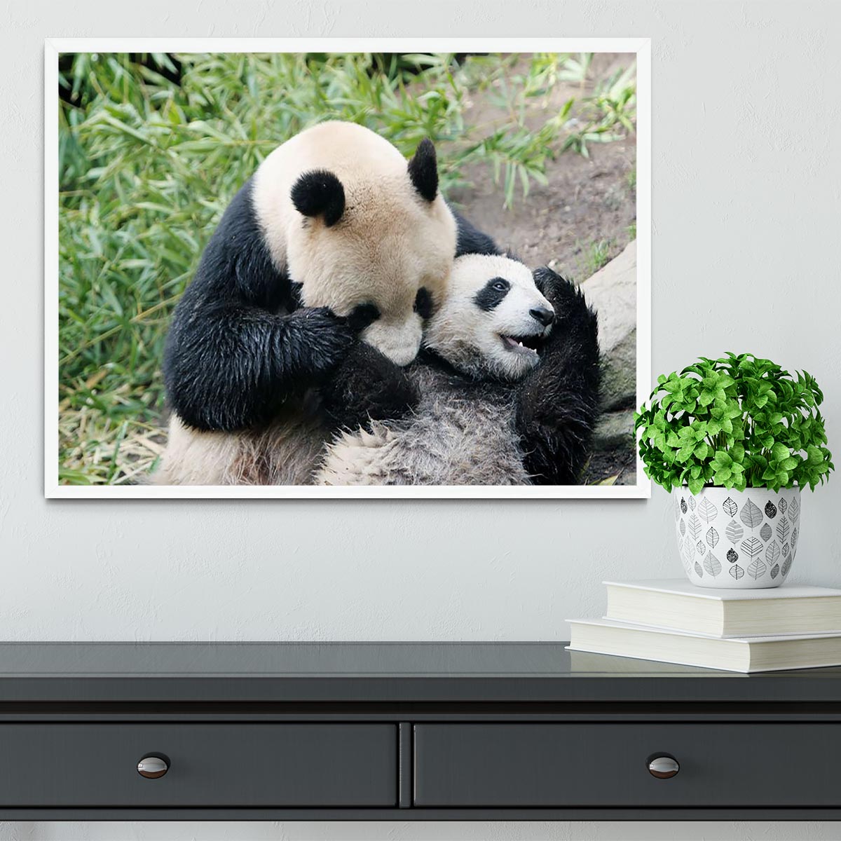 Framed print of a panda bear and her cub, showcasing vibrant colors and intricate details in a handmade frame.