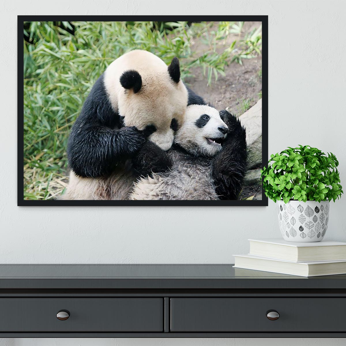 Framed print of a panda bear and her cub, showcasing vibrant colors and intricate details in a handmade frame.