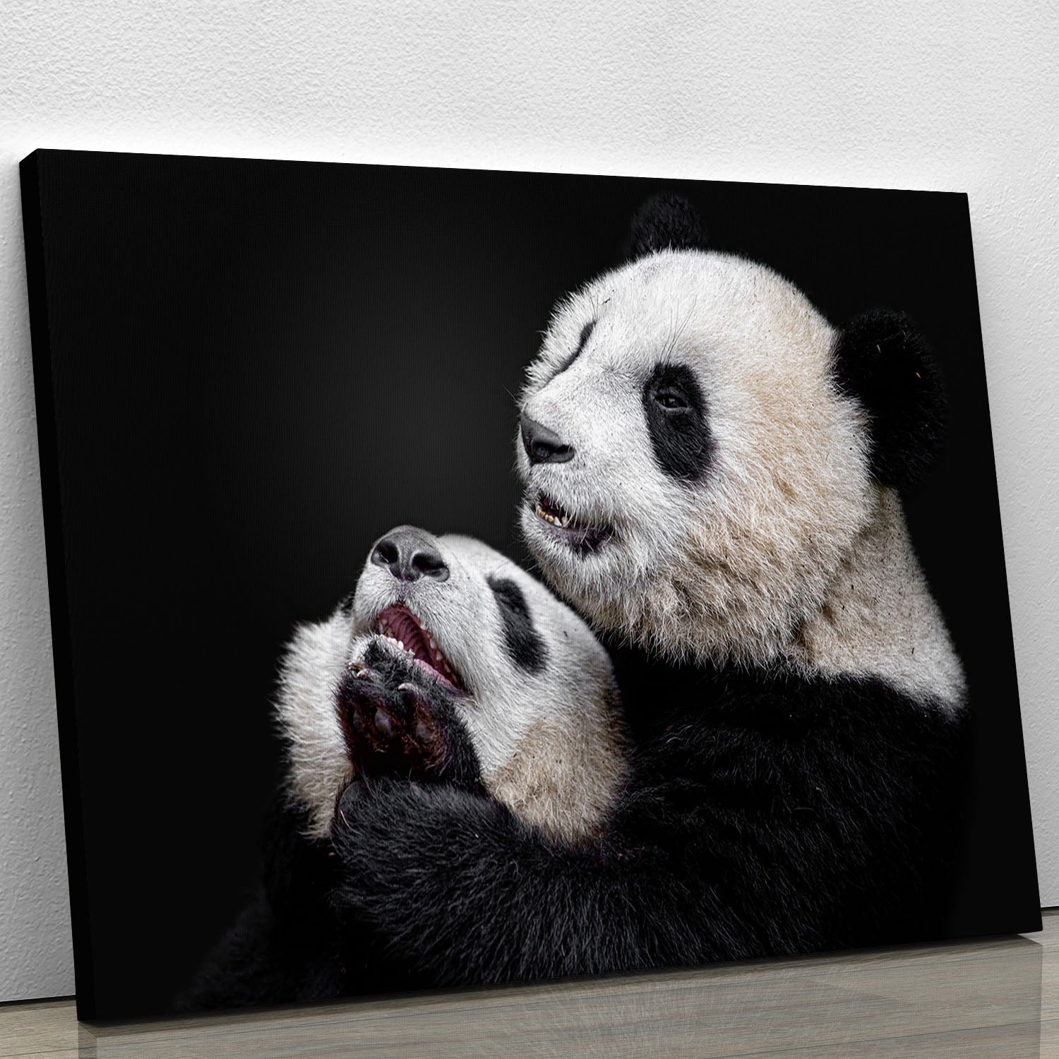 A vibrant canvas print featuring playful pandas in a lush green setting, perfect for home decor.