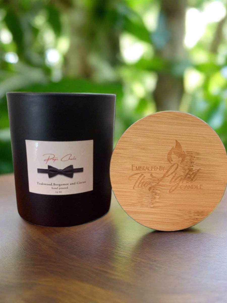 Papi Chulo 14 oz Soy Candle in a frosted container with a bamboo lid, showcasing its elegant design and inviting fragrance.