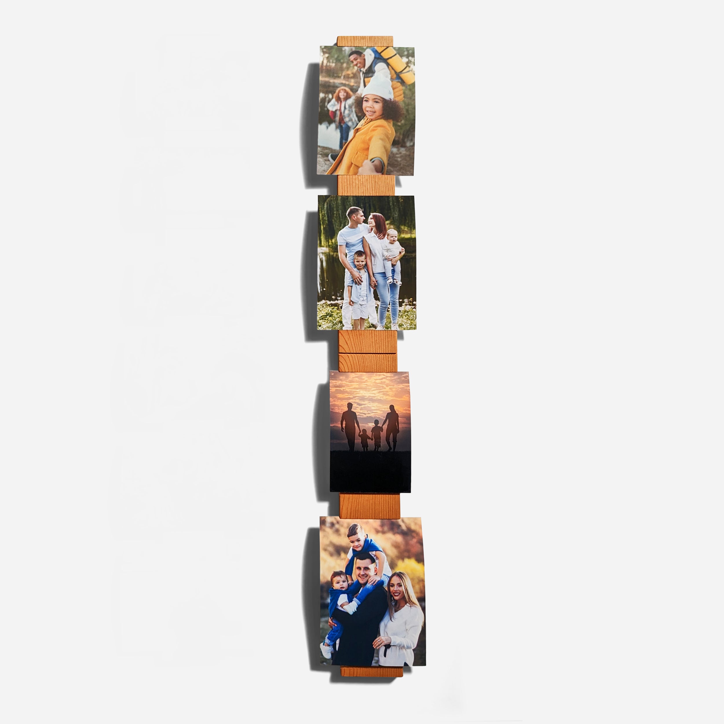 A contemporary wall-mounted photo holder made from sustainable wood, showcasing four photo slots for 3" x 5" or 4" x 6" pictures.