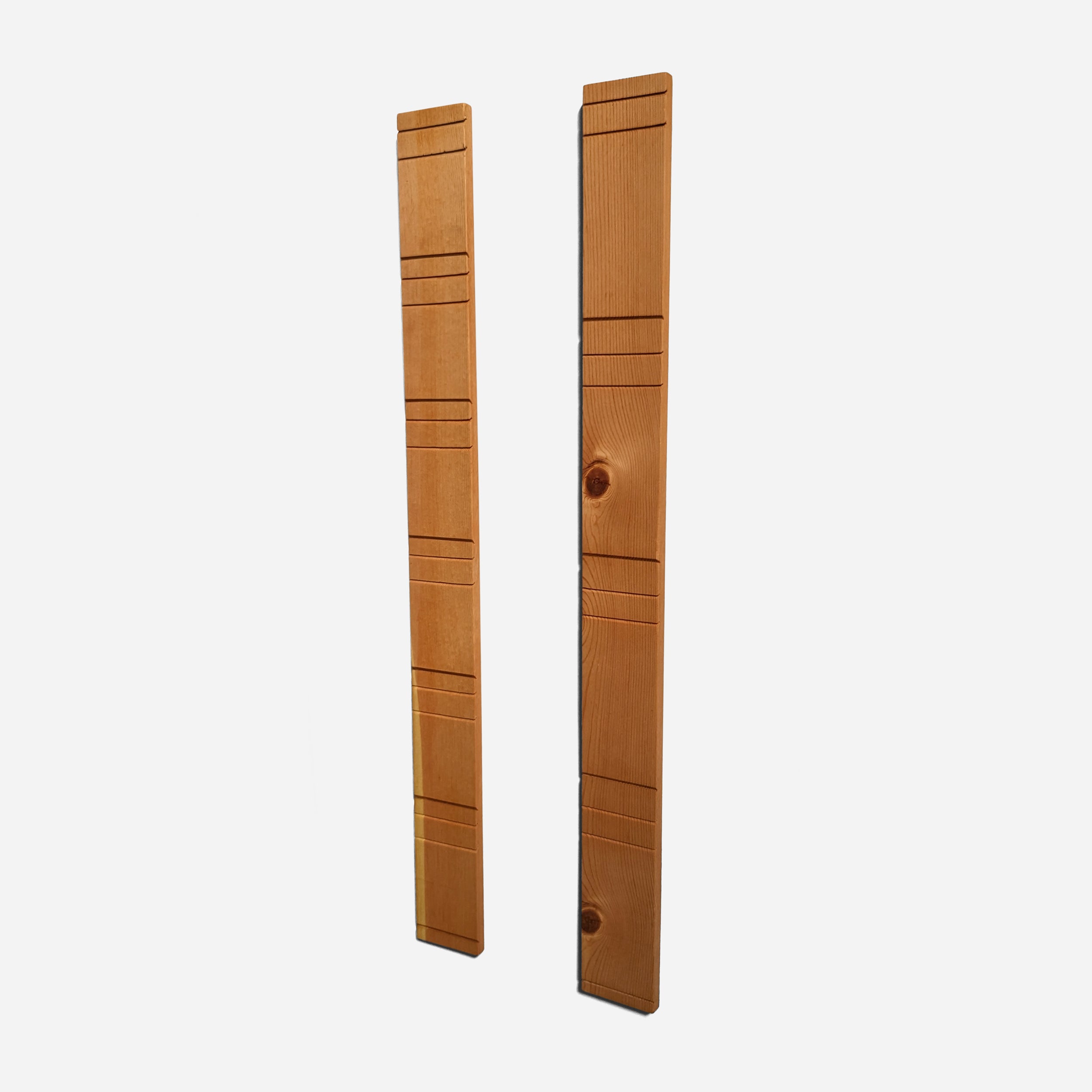 A contemporary wall-mounted photo holder made from sustainable wood, showcasing four photo slots for 3" x 5" or 4" x 6" pictures.