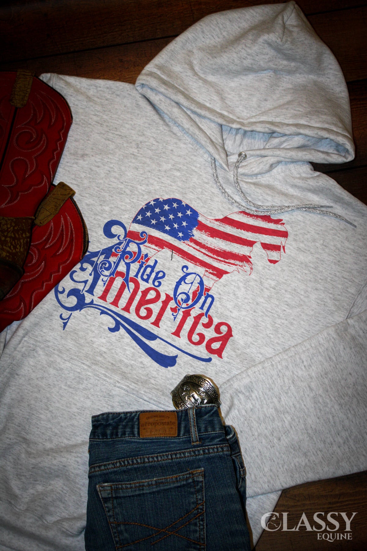 A cozy hooded sweatshirt featuring a patriotic Gypsy design with the text 'Ride on America', perfect for casual wear.