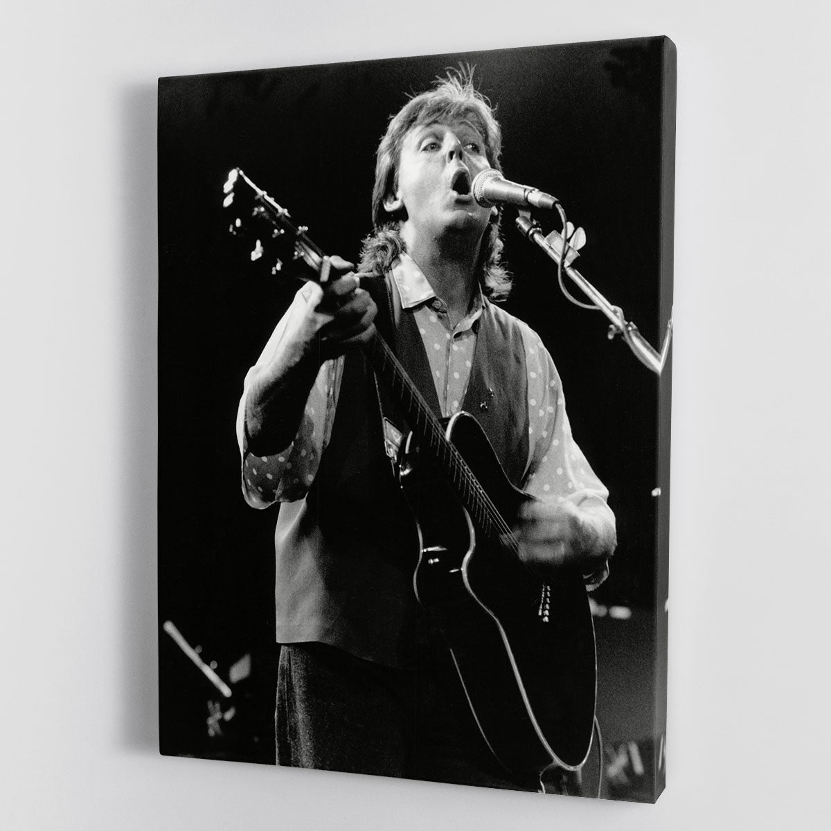 Canvas print of Paul McCartney performing on stage in 1989, showcasing vibrant colors and details.