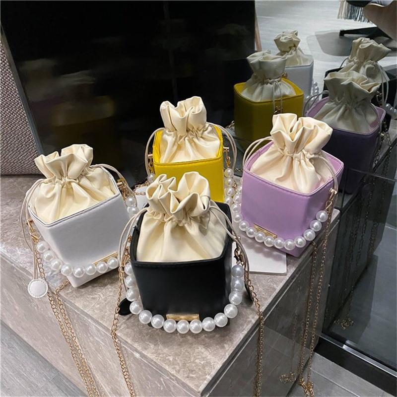 PB0016 Fashion Mini Pearl Chain Wallet in four colors: white, yellow, purple, and black, featuring a pearl chain and stylish design.
