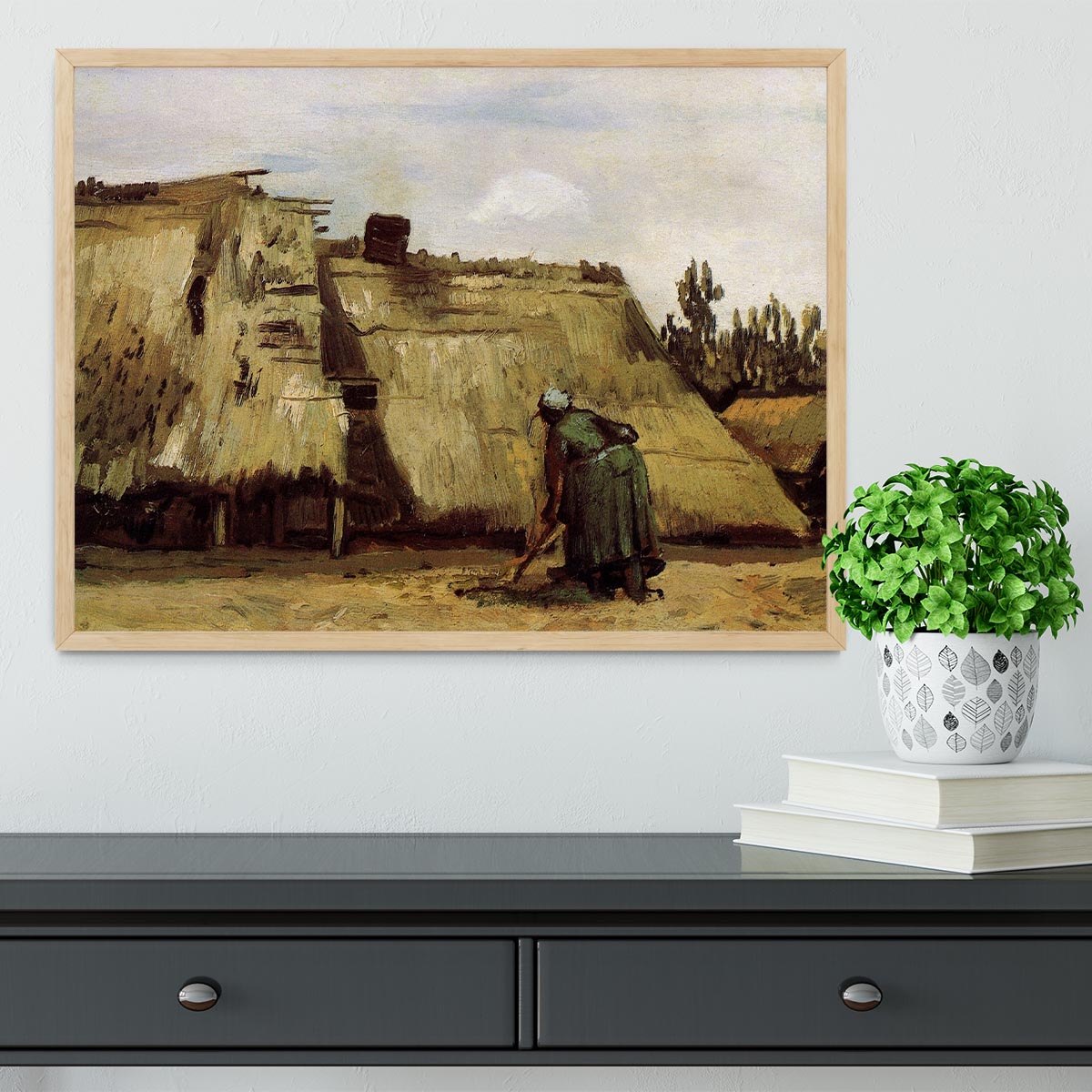 Framed print of Van Gogh's Peasant Woman Digging, showcasing vibrant colors and intricate details.