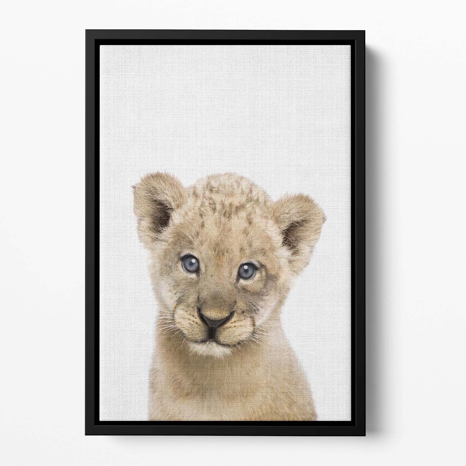 A vibrant abstract canvas featuring a playful baby lion, elegantly framed in a floating wooden frame.
