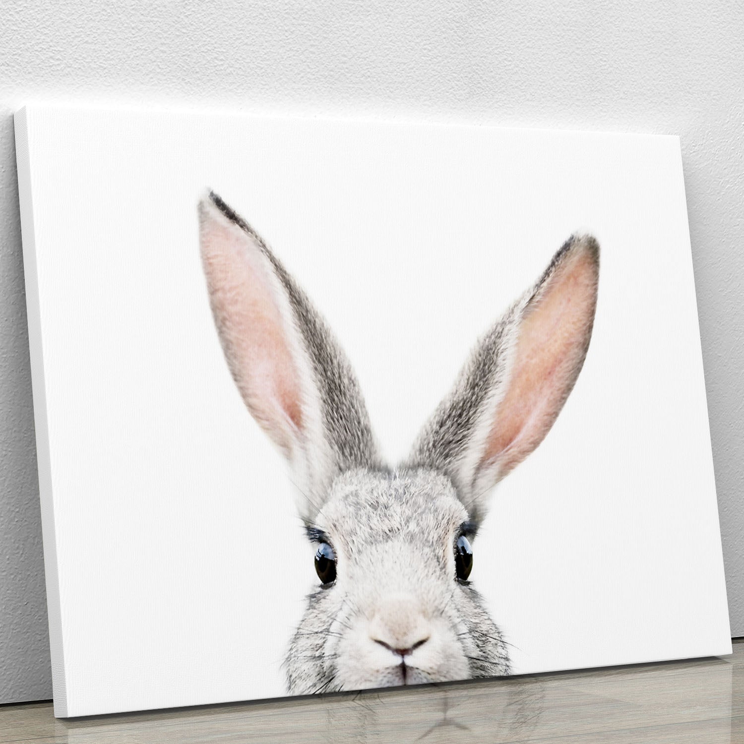 A charming canvas print featuring a whimsical bunny peeking out, perfect for home decor.