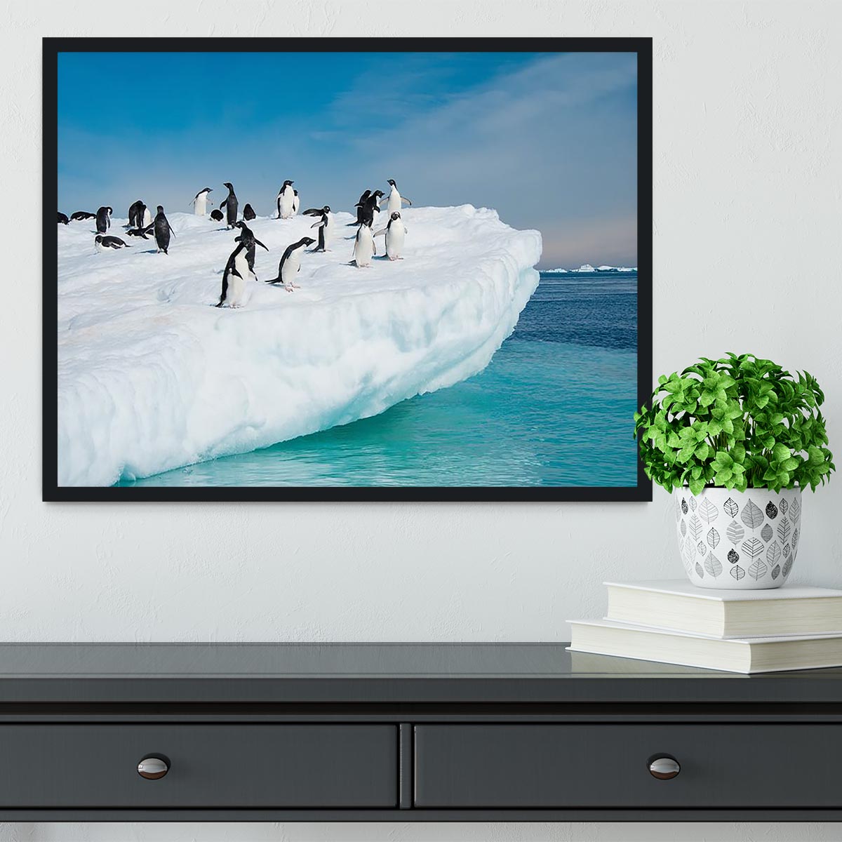 Framed print of penguins on an iceberg, showcasing vibrant colors and quality craftsmanship.