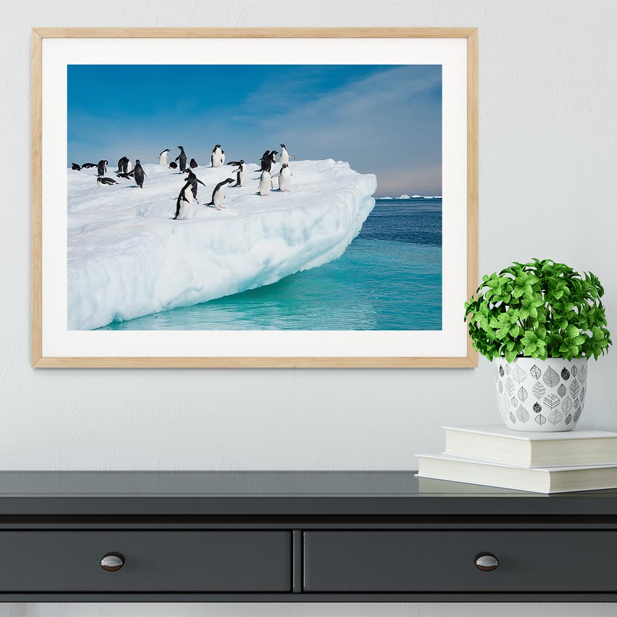 Framed print of penguins on an iceberg, showcasing vibrant colors and quality craftsmanship.