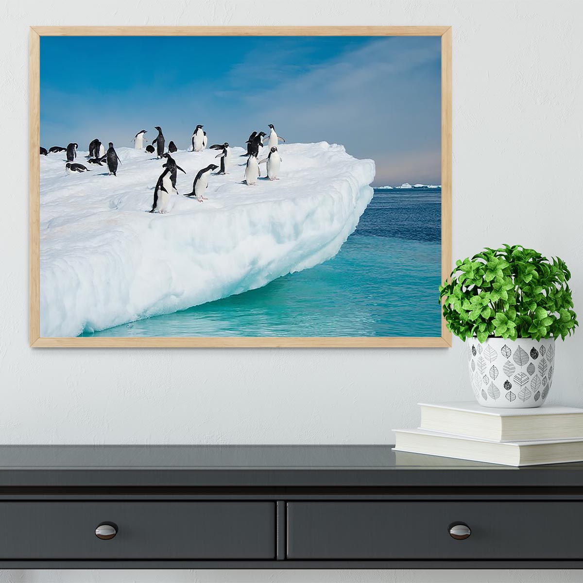 Framed print of penguins on an iceberg, showcasing vibrant colors and quality craftsmanship.