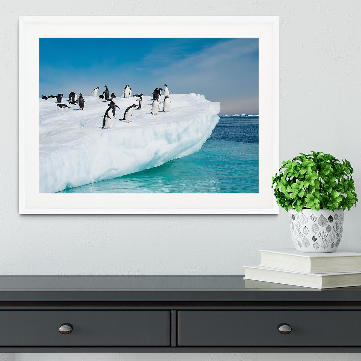 Framed print of penguins on an iceberg, showcasing vibrant colors and quality craftsmanship.