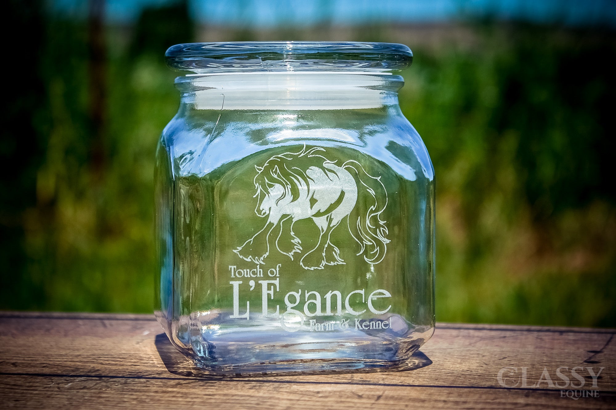 A personalized 20 oz glass jar with a lid, featuring custom engraving options and an elegant equestrian design, perfect for storage or gifting.