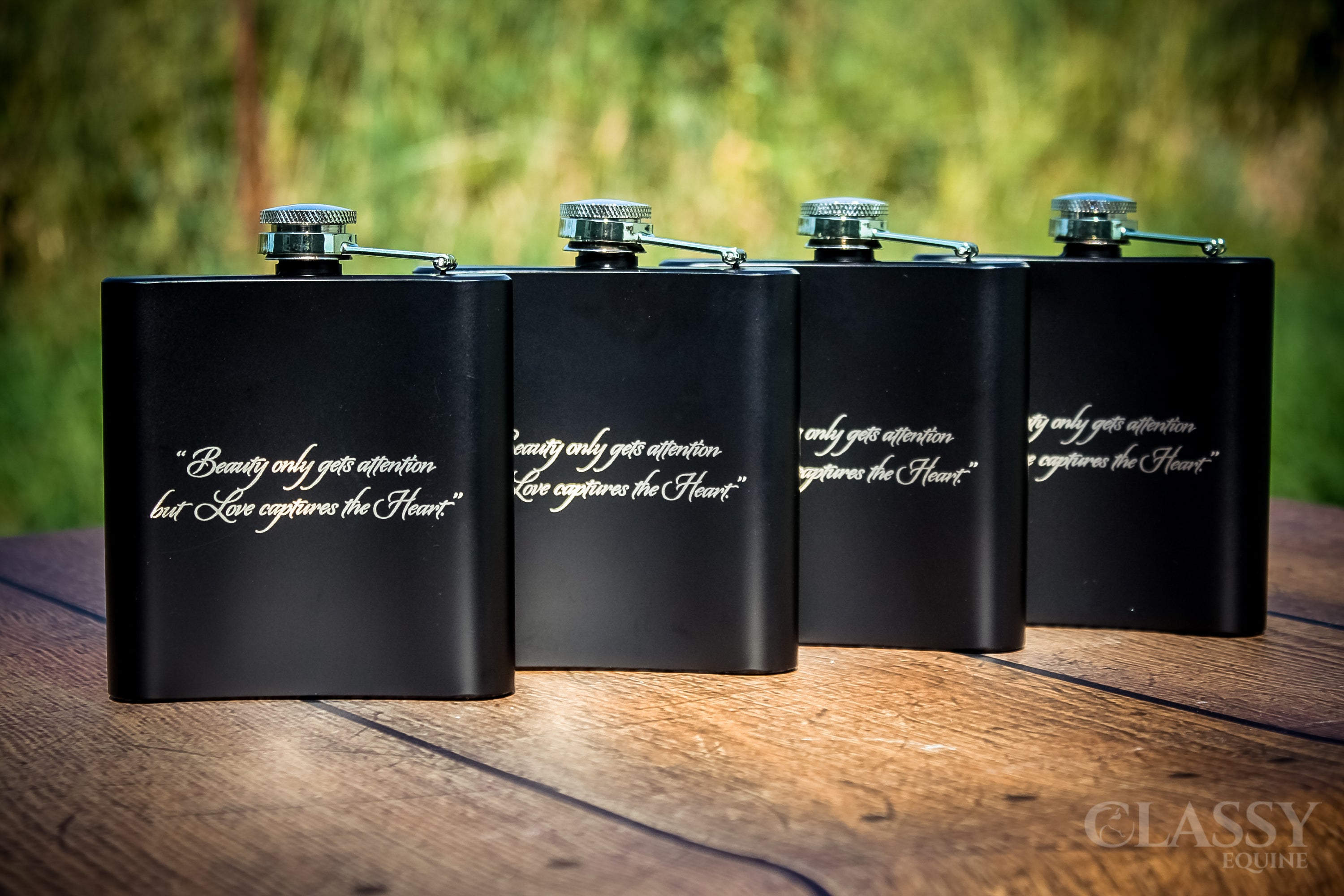Personalized black stainless steel 6 oz hip flask with custom engraving options.