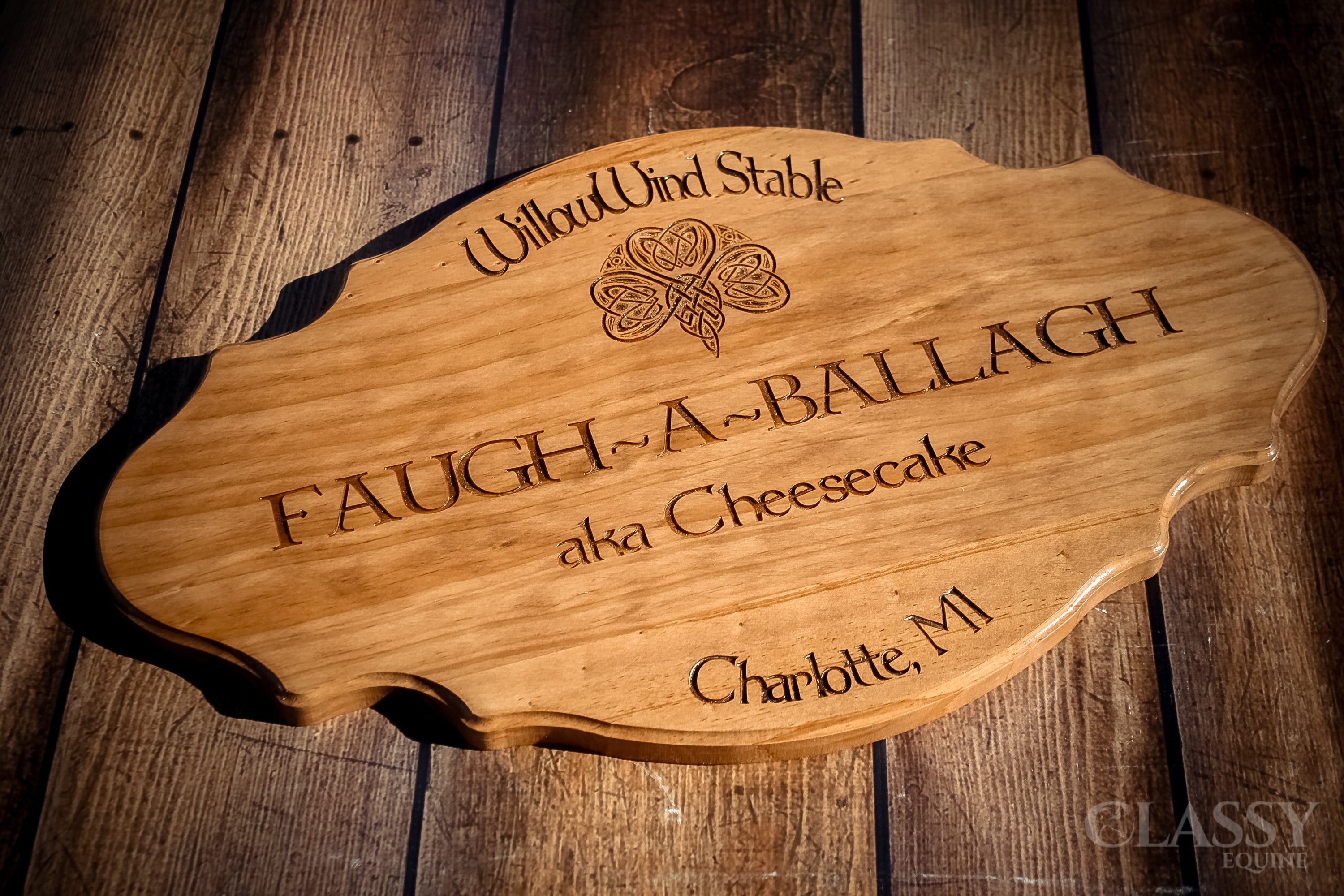 Personalized wooden stall door plaque in French provincial style, featuring custom engraving for horse's name and farm logo.