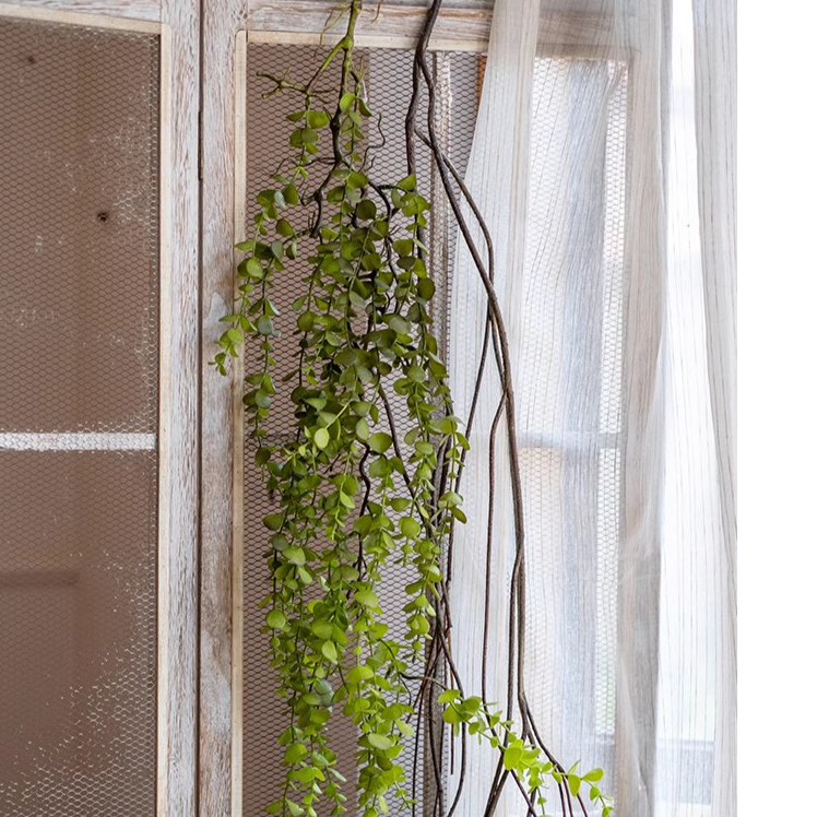 A detailed view of the Petite Foliage Weeping Fern Sprig, showcasing its lush green leaves and realistic texture, perfect for home decor.