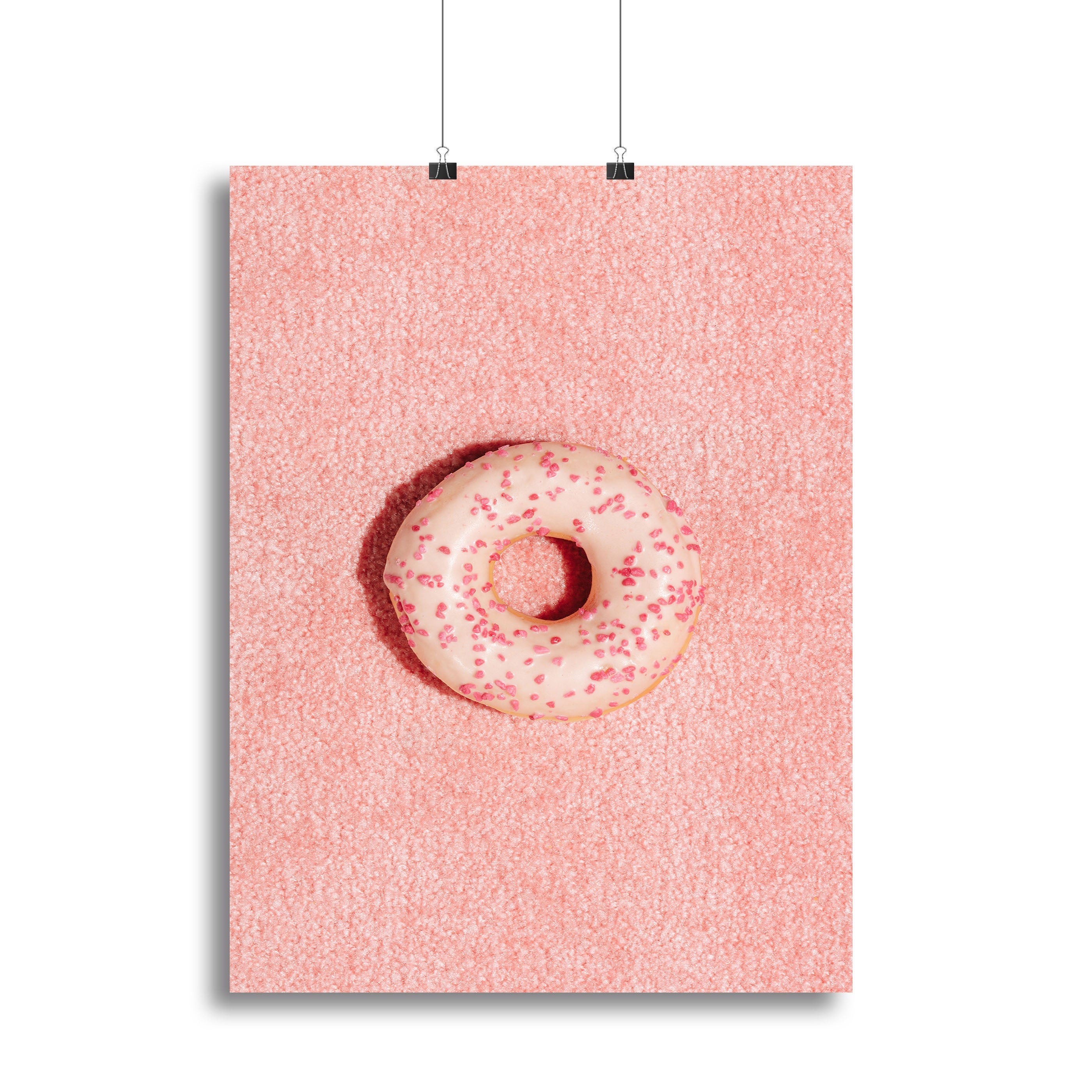 A vibrant pink doughnut canvas print showcasing a whimsical design, perfect for home decor.