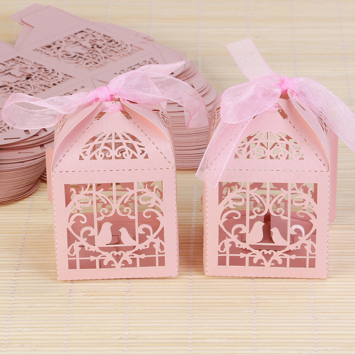 A pack of 10 pink dove bird boxes designed for baby naming ceremonies, elegantly shaped and perfect for favors.