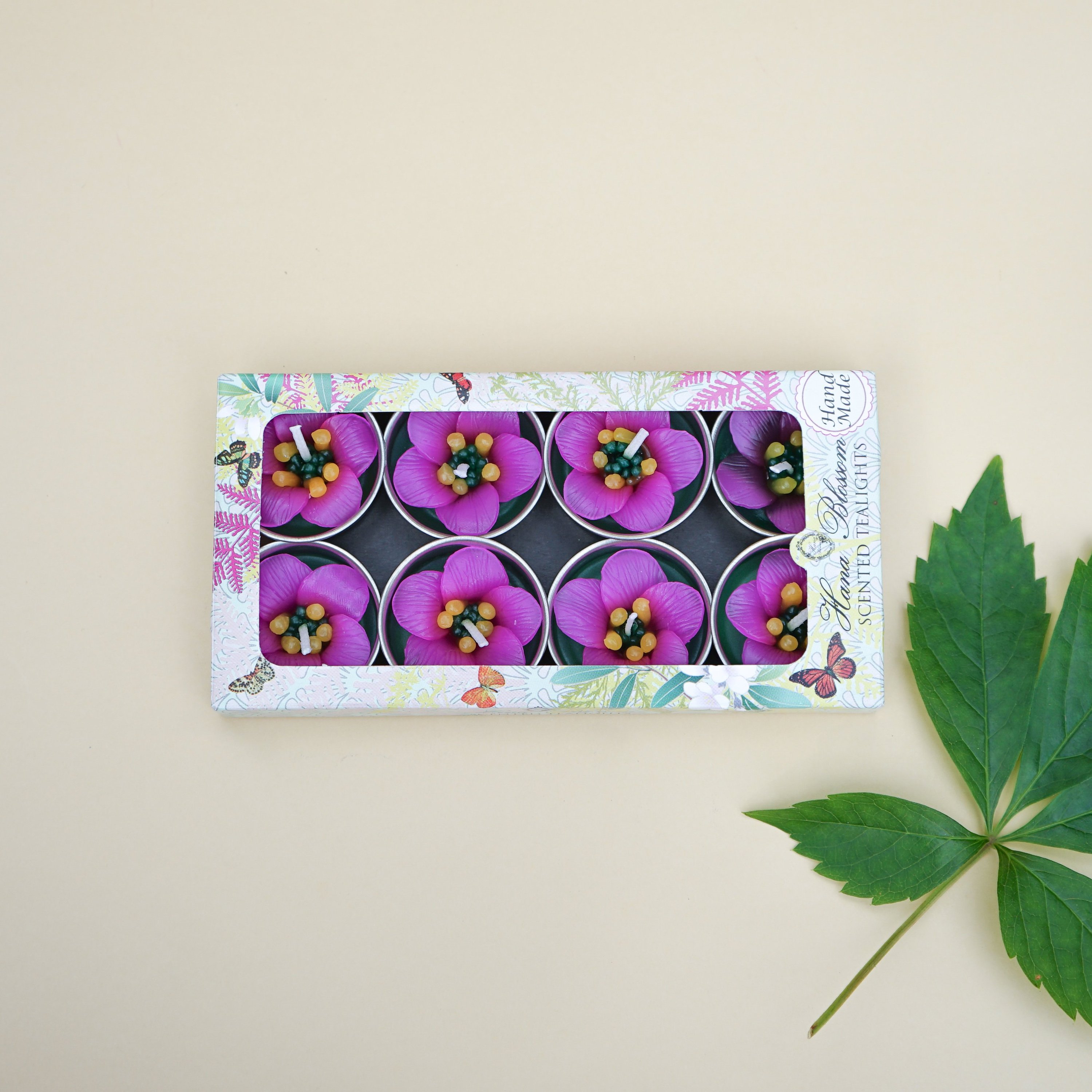 A set of Pink Escallonia Scented Tealights, showcasing their beautiful pink flower design and delicate petals, perfect for home decor.